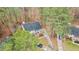 Aerial view of the home, surrounded by mature trees and a long driveway at 402 Shannonford Ct, Wake Forest, NC 27587