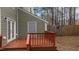 Backyard deck with access door surrounded by forest at 402 Shannonford Ct, Wake Forest, NC 27587