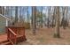 Backyard with a wooden fence surrounded by lush trees at 402 Shannonford Ct, Wake Forest, NC 27587
