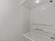Simple bathroom featuring neutral walls and a white bathtub with shower head at 402 Shannonford Ct, Wake Forest, NC 27587