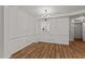 Open dining room with wood floors and a view into the kitchen at 402 Shannonford Ct, Wake Forest, NC 27587