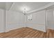 Open dining room with wood floors and a view into the kitchen at 402 Shannonford Ct, Wake Forest, NC 27587