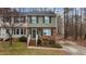 Charming townhome with brick accents, green shutters, and a well-maintained front yard at 402 Shannonford Ct, Wake Forest, NC 27587