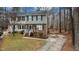 Two-story townhome with brick facade, green shutters, and a long driveway at 402 Shannonford Ct, Wake Forest, NC 27587