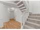 Inviting foyer features hardwood-style floors, adjacent staircase, and neutral paint colors at 402 Shannonford Ct, Wake Forest, NC 27587