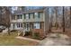 Two-story home with brick facade, green shutters and driveway at 402 Shannonford Ct, Wake Forest, NC 27587