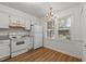 Cozy kitchen featuring white appliances, cabinets, and granite countertops at 402 Shannonford Ct, Wake Forest, NC 27587