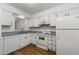 White kitchen featuring white appliances, cabinets, and granite countertops at 402 Shannonford Ct, Wake Forest, NC 27587