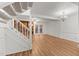 Open living room with hardwood floors, staircase, and french doors at 402 Shannonford Ct, Wake Forest, NC 27587