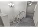 Bright staircase featuring neutral walls, white trim, and carpeted stairs at 402 Shannonford Ct, Wake Forest, NC 27587