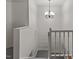 Bright staircase featuring neutral walls, white trim, and a decorative chandelier at 402 Shannonford Ct, Wake Forest, NC 27587