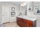 Bathroom with wood cabinets, large mirror and decor at 4052 Dunkirk Dr, Burlington, NC 27215