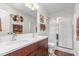 Bathroom featuring a double vanity, large mirror, and glass-enclosed shower at 4052 Dunkirk Dr, Burlington, NC 27215