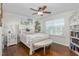 Bright bedroom featuring a large window, ceiling fan, and hardwood floors at 4052 Dunkirk Dr, Burlington, NC 27215