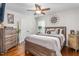 Cozy bedroom with a wood-framed bed, ceiling fan, and decorative accents at 4052 Dunkirk Dr, Burlington, NC 27215