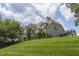 Spacious home on a lush green lawn, showcasing a stone facade and a multi-level roofline at 4052 Dunkirk Dr, Burlington, NC 27215
