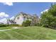 Beautiful home with stone accents, manicured lawn, and mature trees offers great curb appeal at 4052 Dunkirk Dr, Burlington, NC 27215