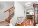 Inviting foyer featuring hardwood floors, a staircase with carpeted treads, and an adjacent living room at 4052 Dunkirk Dr, Burlington, NC 27215