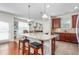 Bright eat-in kitchen with granite counters, center island, stainless appliances, and tile backsplash at 4052 Dunkirk Dr, Burlington, NC 27215