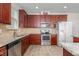 Updated kitchen features stainless steel appliances, granite counters, and tiled floor at 4052 Dunkirk Dr, Burlington, NC 27215