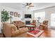 Inviting living room boasting a fireplace, hardwood floors, ample lighting, and well-coordinated furniture at 4052 Dunkirk Dr, Burlington, NC 27215