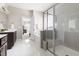 Bright bathroom with double sinks, white tile flooring, walk-in shower and tub at 428 Boulder Point Dr, Chapel Hill, NC 27516