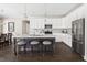 Bright kitchen with white cabinets, stainless steel appliances, an island with seating, and pendant lighting at 428 Boulder Point Dr, Chapel Hill, NC 27516