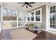 Relaxing screened porch with stylish seating, ceiling fan, and wood flooring for outdoor enjoyment at 428 Boulder Point Dr, Chapel Hill, NC 27516