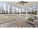 Screened porch features a ceiling fan, wood flooring, and scenic backyard views at 428 Boulder Point Dr, Chapel Hill, NC 27516