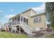 Back of house featuring a wooden screened-in porch with white stairs leading to a landscaped backyard at 48 Grandwood Cir, Durham, NC 27712