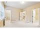 Neutral bedroom featuring large window and access to an ensuite and walk-in closets at 48 Grandwood Cir, Durham, NC 27712