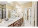 Spacious bathroom with double sinks, a large mirror, and a walk-in closet at 48 Grandwood Cir, Durham, NC 27712