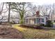 Private backyard featuring a screened porch and lush landscaping with a shed at 513 Princeton St, Raleigh, NC 27609