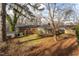 Spacious backyard with a screened porch, mature trees and a storage shed at 513 Princeton St, Raleigh, NC 27609