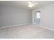 Bright, neutral bedroom with a ceiling fan and doorway leading to the next room at 513 Princeton St, Raleigh, NC 27609