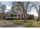 Charming brick home with a well-maintained front yard and mature trees at 513 Princeton St, Raleigh, NC 27609