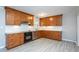 Modern kitchen featuring stainless steel appliances, granite counters, tile backsplash, and wood cabinets at 513 Princeton St, Raleigh, NC 27609