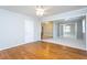 Open floor plan featuring gleaming hardwood floors, a ceiling fan, and plenty of natural light at 513 Princeton St, Raleigh, NC 27609