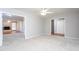 Open living room with neutral carpet, ceiling fan, and views to adjacent rooms at 513 Princeton St, Raleigh, NC 27609