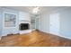 Living room features a white brick fireplace and doors to the porch, providing a bright indoor-outdoor space at 513 Princeton St, Raleigh, NC 27609