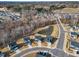 Aerial view of a new development and neighborhood with a scenic pond at 525 Marion Hills Way, Knightdale, NC 27545
