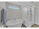 Elegant bathroom featuring a standalone tub, glass-enclosed shower, and modern fixtures at 525 Marion Hills Way, Knightdale, NC 27545