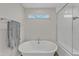 Elegant bathroom featuring a standalone tub, glass-enclosed shower, and modern fixtures at 525 Marion Hills Way, Knightdale, NC 27545