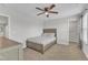 Bedroom features a small window, neutral paint, carpet and a bed with grey and white patterned bedding at 525 Marion Hills Way, Knightdale, NC 27545