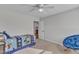 Bedroom featuring a blue chair, ceiling fan, carpet, and closet at 525 Marion Hills Way, Knightdale, NC 27545