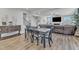 Open-concept dining area with a wooden table set and natural light flowing into the living space at 525 Marion Hills Way, Knightdale, NC 27545