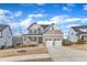 Beautiful two-story home with a front porch, stone accents, and a two-car garage at 525 Marion Hills Way, Knightdale, NC 27545