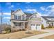 Inviting two-story home with a front porch, stone accents, and a two-car garage at 525 Marion Hills Way, Knightdale, NC 27545