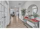 Bright foyer featuring wood floors, stylish decor, and an open view into the living area at 525 Marion Hills Way, Knightdale, NC 27545
