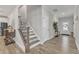 Bright foyer showcases staircase with decorative risers and view to front entry, creating a stylish and welcoming space at 525 Marion Hills Way, Knightdale, NC 27545